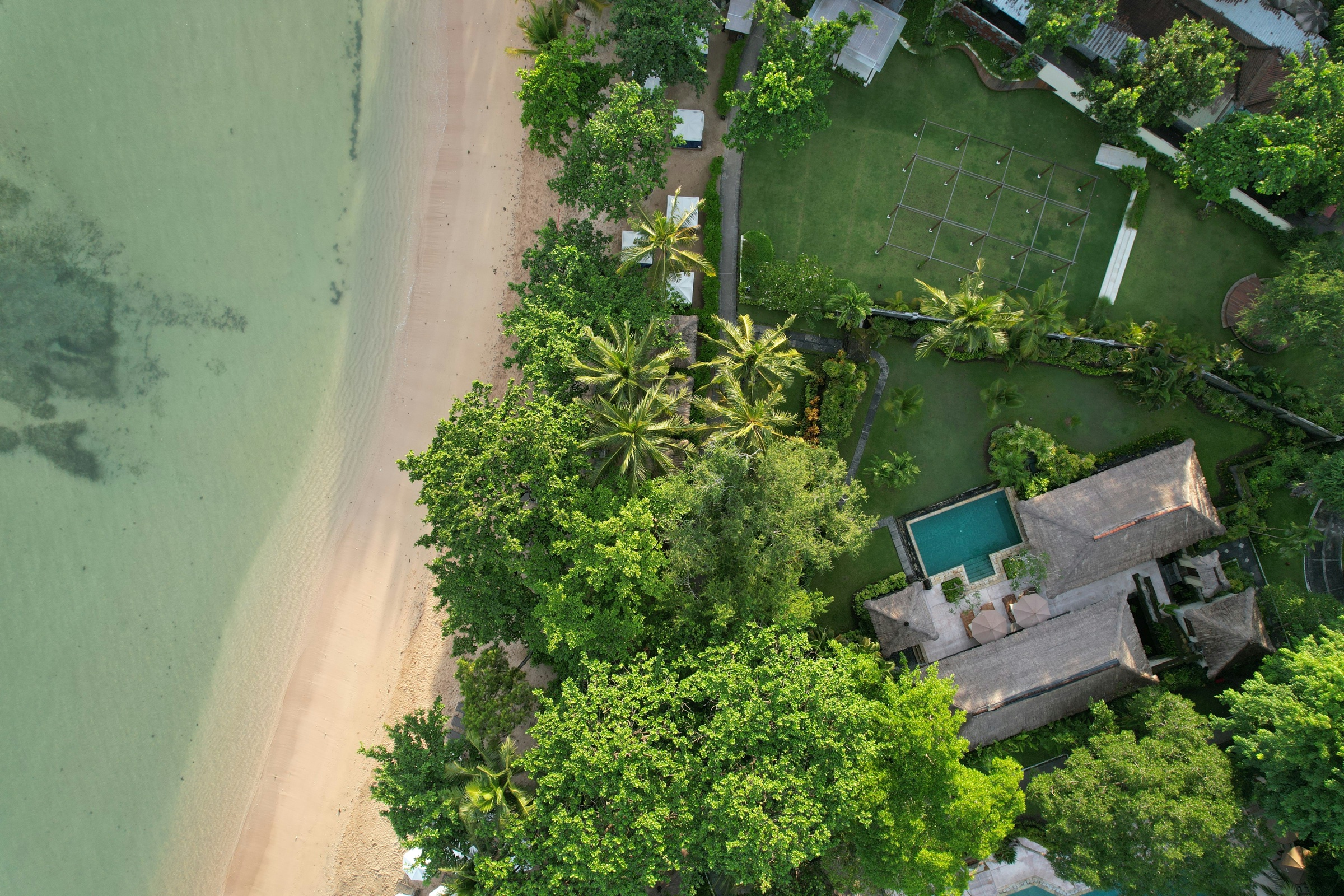 Aerial view of beachfront private villa with pool